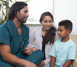 Health care provider talking to woman and boy.